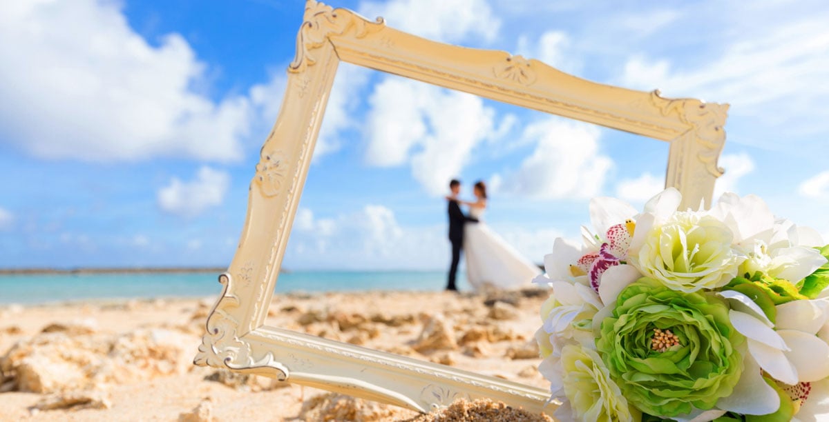 Couple on wedding day with frame and flowers 