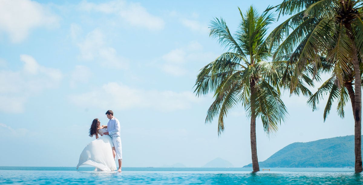 Newly married couple after wedding in luxury resort near swimming pool and sea