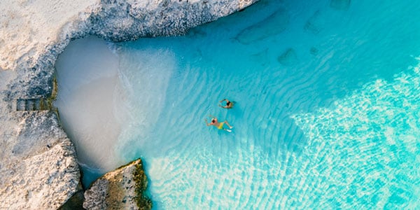 Couple floating in water in Aruba