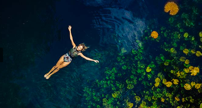 Woman floating in cenote