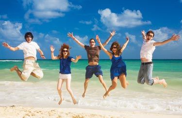 Family jumping in the sand